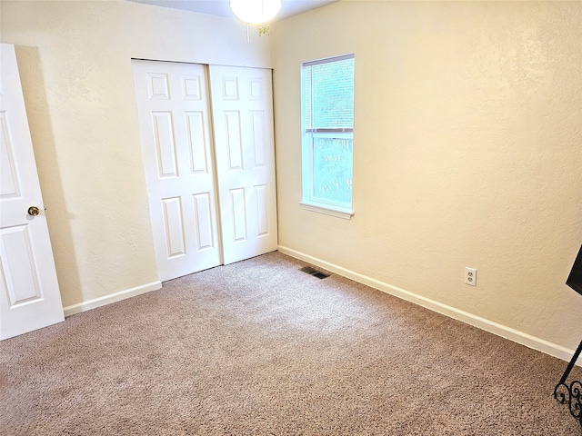 1109 W Main St, Hamilton, MT 59840 - unfurnished bedroom featuring carpet, a textured wall, and a closet