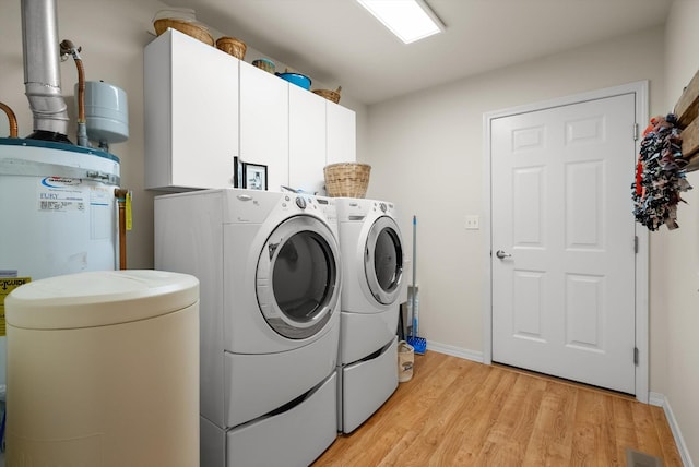 36 W Northview Loop, Kalispell, MT 59901 - washroom with independent washer and dryer, cabinet space, light wood finished floors, and electric water heater