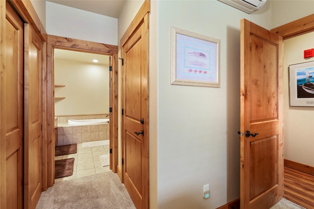 7175 US Highway 93 S Unit 4-102, Lakeside, MT 59922 - hall with an AC wall unit and tile patterned floors