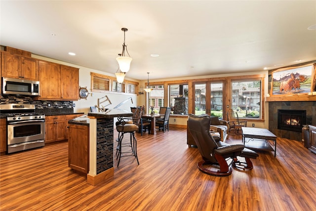 7175 US Highway 93 S Unit 4-102, Lakeside, MT 59922 - kitchen with stainless steel appliances, open floor plan, a breakfast bar, dark wood-style flooring, and recessed lighting