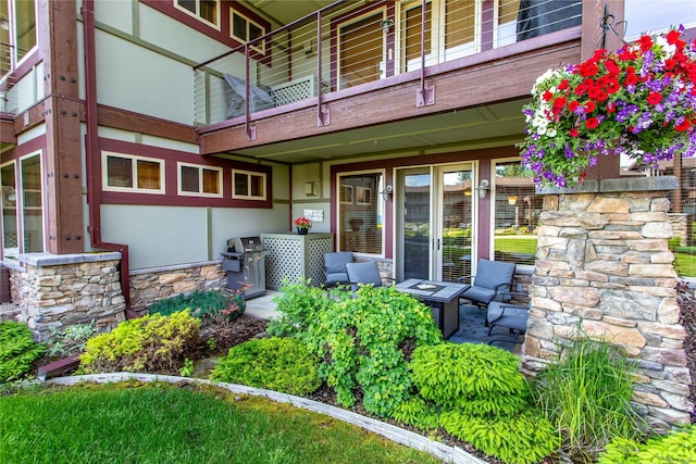 7175 US Highway 93 S Unit 4-102, Lakeside, MT 59922 - doorway to property featuring a balcony, stone siding, and stucco siding