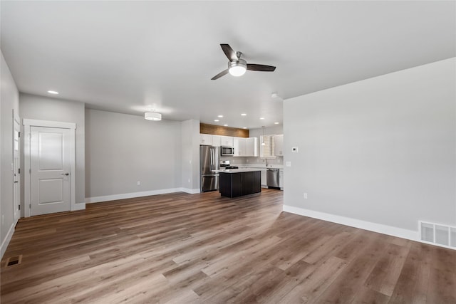 534 Colorado Ave, Whitefish, MT 59937 - unfurnished living room with ceiling fan, recessed lighting, and wood finished floors
