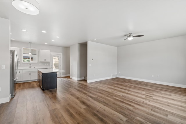 534 Colorado Ave, Whitefish, MT 59937 - unfurnished living room with wood finished floors, ceiling fan, and recessed lighting
