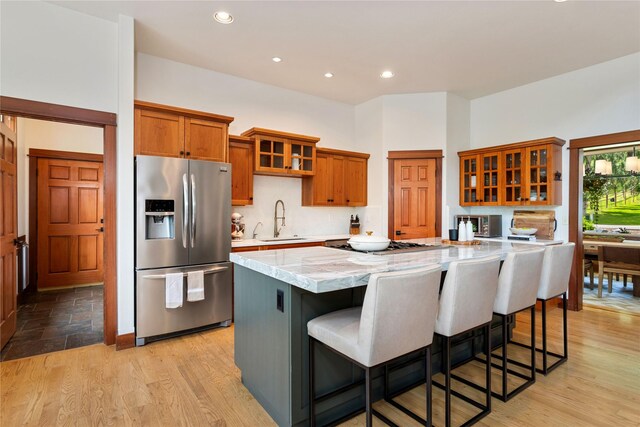 255 Windsor Ct, Bigfork, MT 59911 - kitchen featuring stainless steel appliances, a center island, brown cabinetry, glass insert cabinets, and recessed lighting