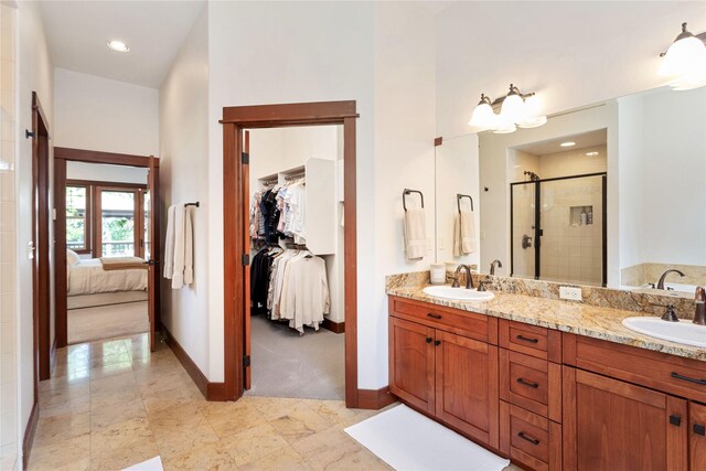 255 Windsor Ct, Bigfork, MT 59911 - ensuite bathroom with a shower stall, double vanity, a walk in closet, and recessed lighting