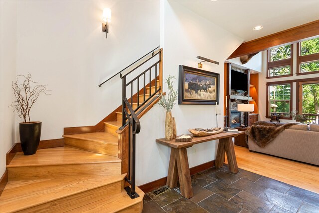 255 Windsor Ct, Bigfork, MT 59911 - stairway featuring a fireplace, stone tile flooring, and recessed lighting