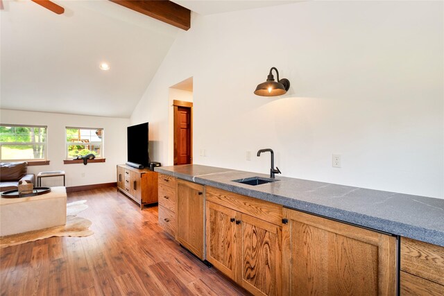 255 Windsor Ct, Bigfork, MT 59911 - kitchen with dark countertops, light wood-style floors, ceiling fan, and brown cabinets