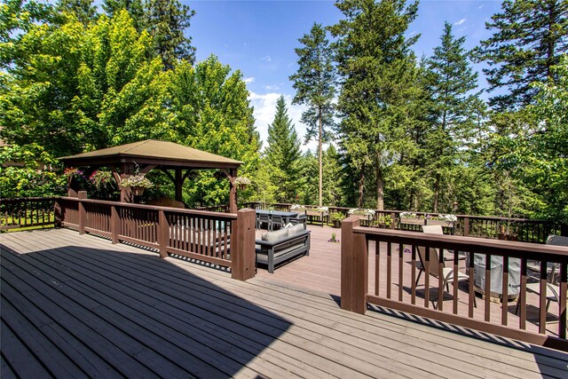 255 Windsor Ct, Bigfork, MT 59911 - wooden terrace featuring a gazebo and view of scattered trees