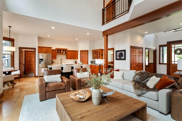 255 Windsor Ct, Bigfork, MT 59911 - living room with a high ceiling, light wood finished floors, and recessed lighting
