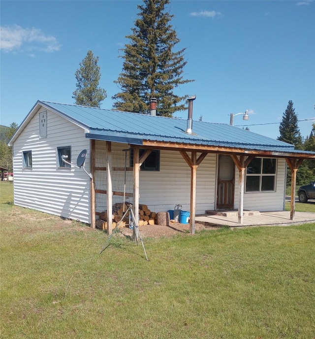 4117 Sherlock Ln, Lincoln, MT 59639 - rear view of house with a lawn and a metal roof