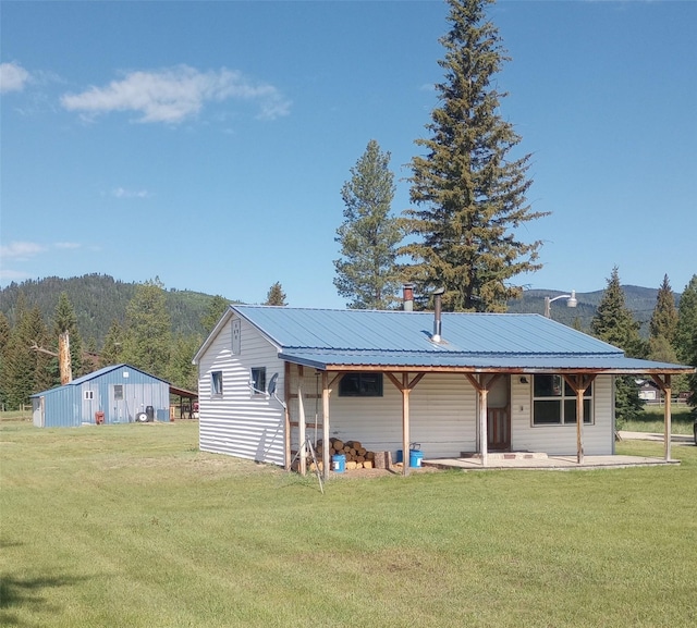 4117 Sherlock Ln, Lincoln, MT 59639 - back of house featuring a yard and a metal roof
