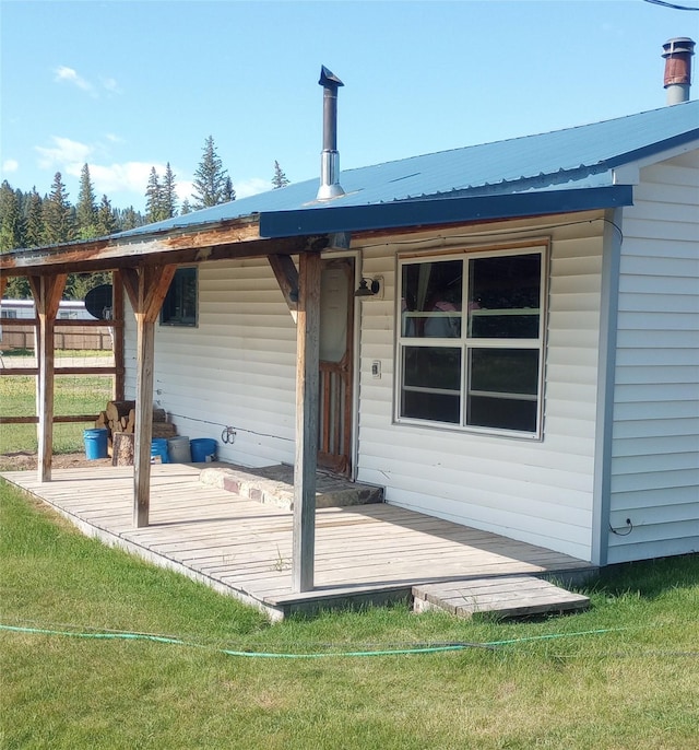 4117 Sherlock Ln, Lincoln, MT 59639 - back of house with a metal roof and a wooden deck