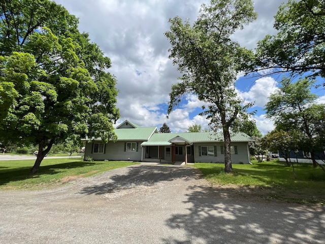 214 Church St, Thompson Falls, MT 59873 - ranch-style house with driveway, a front yard, and a metal roof