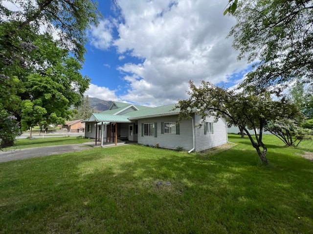 214 Church St, Thompson Falls, MT 59873 - ranch-style house featuring a front lawn and a metal roof