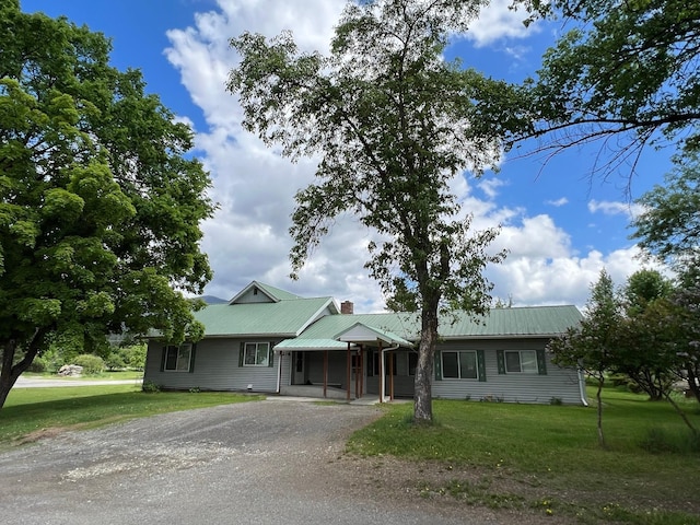 214 Church St, Thompson Falls, MT 59873 - ranch-style house featuring a front yard, driveway, a chimney, and a metal roof