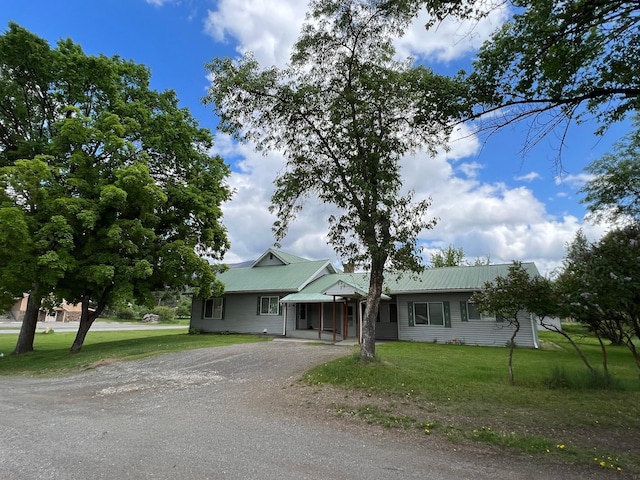 214 Church St, Thompson Falls, MT 59873 - view of front of home featuring driveway, a front yard, and a metal roof