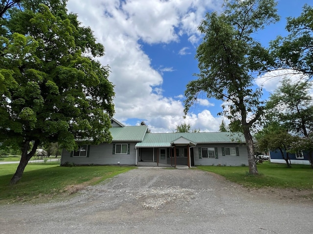 214 Church St, Thompson Falls, MT 59873 - ranch-style house with driveway, a front yard, and a metal roof