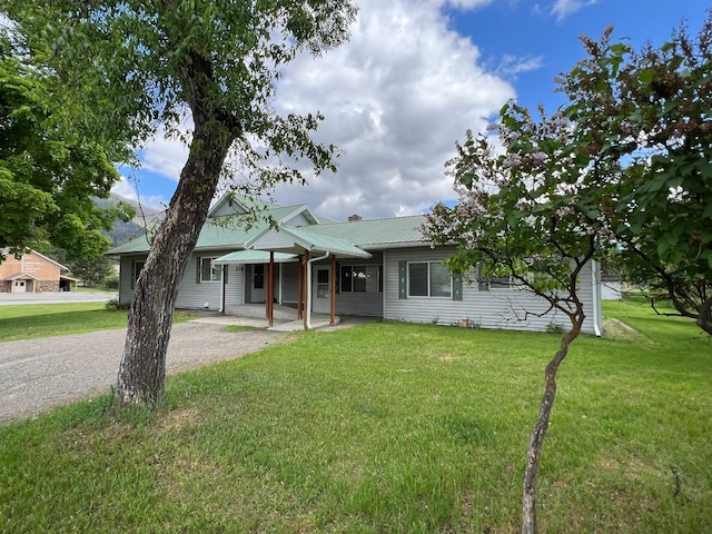 214 Church St, Thompson Falls, MT 59873 - view of front of home with a metal roof and a front yard
