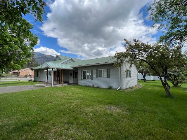 214 Church St, Thompson Falls, MT 59873 - single story home featuring a front yard, a metal roof, and a mountain view