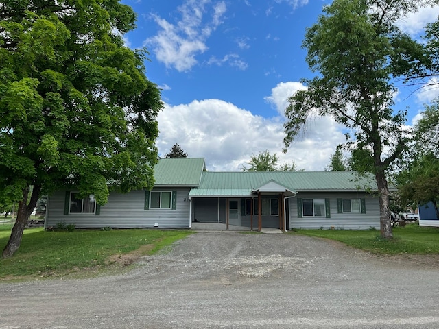 214 Church St, Thompson Falls, MT 59873 - ranch-style home featuring driveway, a front lawn, and a metal roof