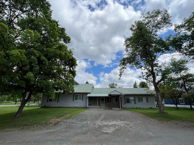 214 Church St, Thompson Falls, MT 59873 - ranch-style house with a front lawn, driveway, and a metal roof