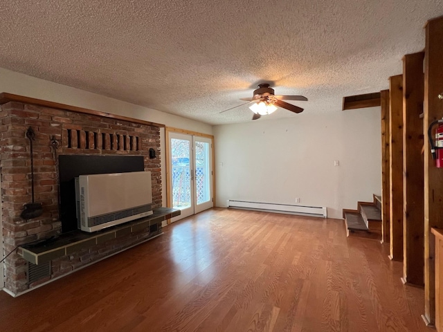 214 Church St, Thompson Falls, MT 59873 - unfurnished living room with baseboard heating, a textured ceiling, ceiling fan, wood finished floors, and stairway