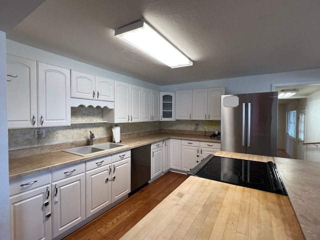 214 Church St, Thompson Falls, MT 59873 - kitchen featuring appliances with stainless steel finishes, dark wood-type flooring, white cabinets, glass insert cabinets, and backsplash