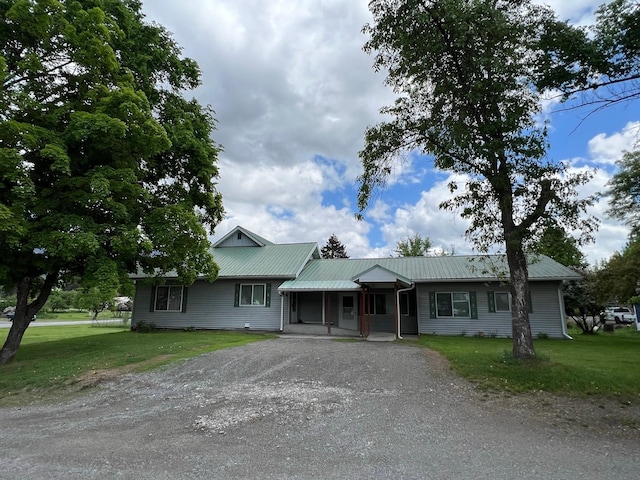 214 Church St, Thompson Falls, MT 59873 - single story home featuring dirt driveway, a front yard, a metal roof, and a porch