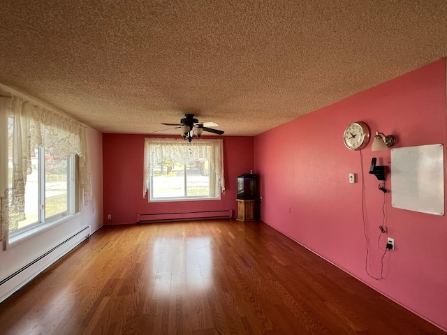 214 Church St, Thompson Falls, MT 59873 - unfurnished room with a baseboard radiator, ceiling fan, healthy amount of natural light, and a textured ceiling