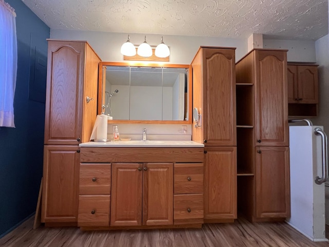 214 Church St, Thompson Falls, MT 59873 - bathroom with wood finished floors, a textured ceiling, and vanity