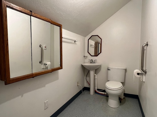 214 Church St, Thompson Falls, MT 59873 - half bathroom with vaulted ceiling, speckle patterned floor, and a textured ceiling