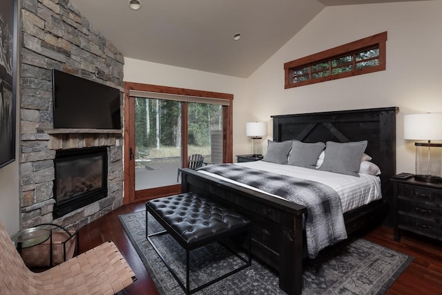 628 Nature Trl, Whitefish, MT 59937 - bedroom with a stone fireplace, lofted ceiling, access to outside, and wood finished floors