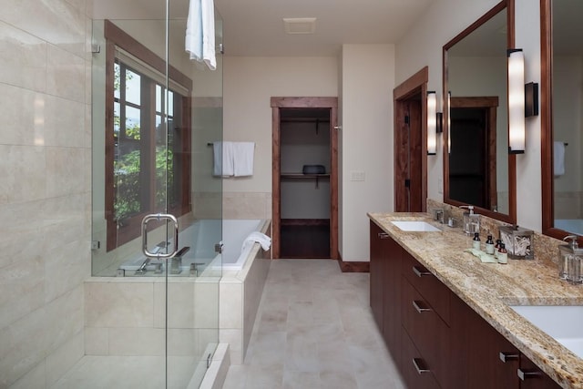 628 Nature Trl, Whitefish, MT 59937 - bathroom with a stall shower, double vanity, a bath, and tile patterned flooring