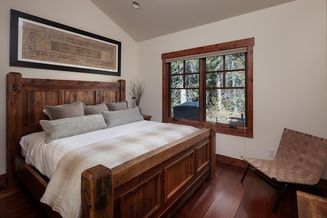 628 Nature Trl, Whitefish, MT 59937 - bedroom with vaulted ceiling and dark wood-style flooring