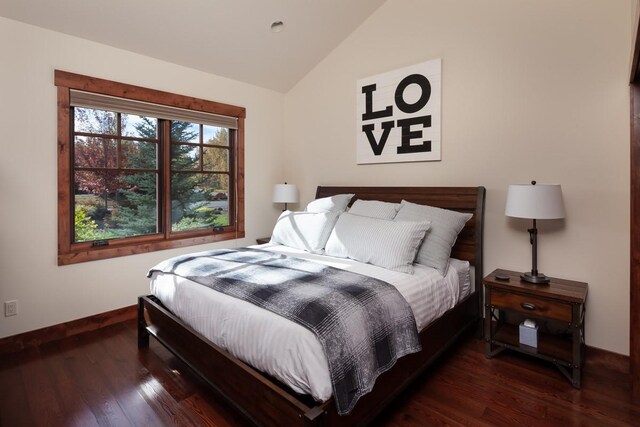 628 Nature Trl, Whitefish, MT 59937 - bedroom with vaulted ceiling and wood finished floors