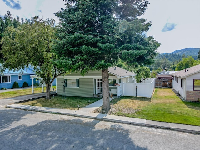 1508 Lolo Ave, Libby, MT 59923 - view of front facade featuring a gate, a mountain view, and asphalt driveway