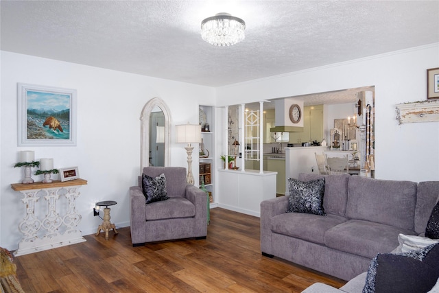 1508 Lolo Ave, Libby, MT 59923 - living room featuring a chandelier, wood finished floors, and a textured ceiling