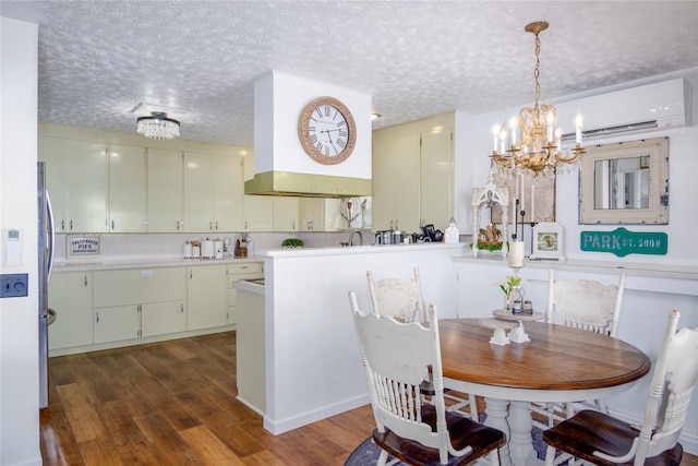 1508 Lolo Ave, Libby, MT 59923 - dining space with dark wood finished floors, a chandelier, a wall unit AC, and a textured ceiling