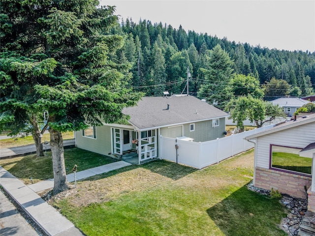 1508 Lolo Ave, Libby, MT 59923 - rear view of property featuring a view of trees and a shingled roof
