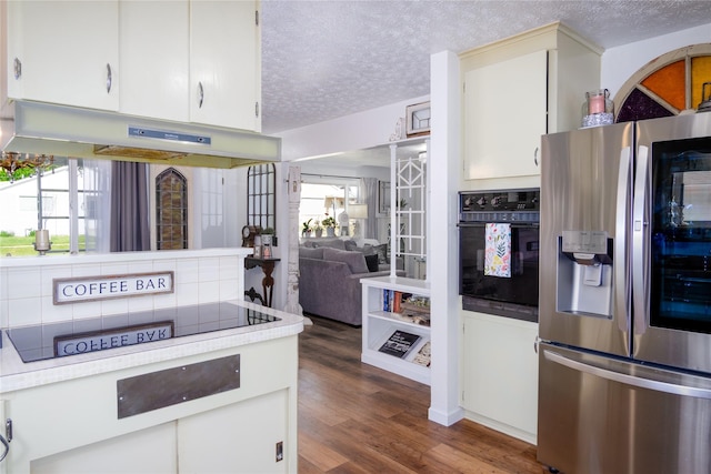 1508 Lolo Ave, Libby, MT 59923 - kitchen with black appliances, light countertops, a textured ceiling, under cabinet range hood, and dark wood finished floors