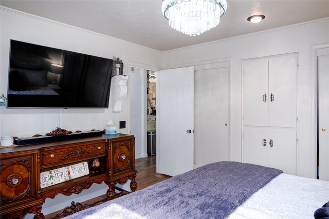 1508 Lolo Ave, Libby, MT 59923 - bedroom with a chandelier, ornamental molding, wood finished floors, and multiple closets