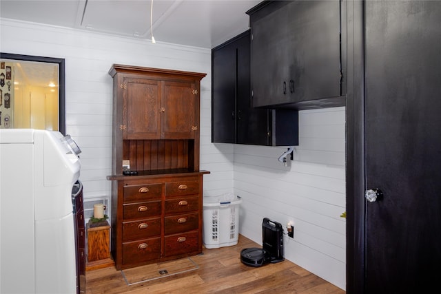 1508 Lolo Ave, Libby, MT 59923 - laundry room featuring washer / dryer, cabinet space, light wood finished floors, and wooden walls