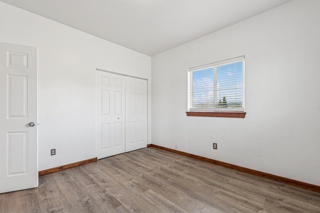 75 N Hill Rd, Kalispell, MT 59901 - unfurnished bedroom featuring wood finished floors and a closet