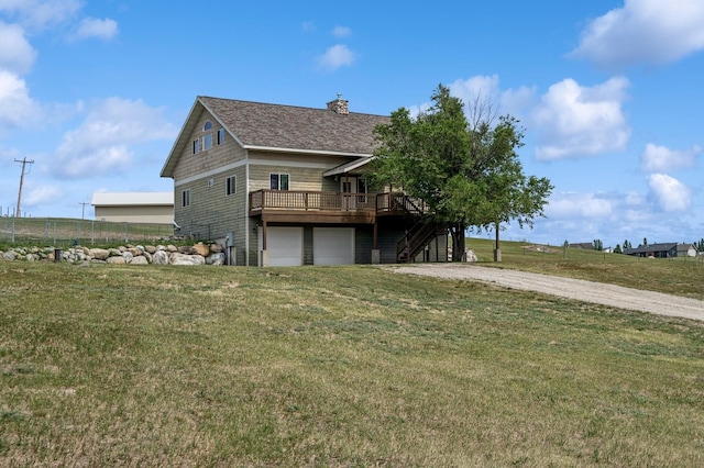 75 N Hill Rd, Kalispell, MT 59901 - view of home's exterior featuring a wooden deck, a yard, stairs, a chimney, and an attached garage