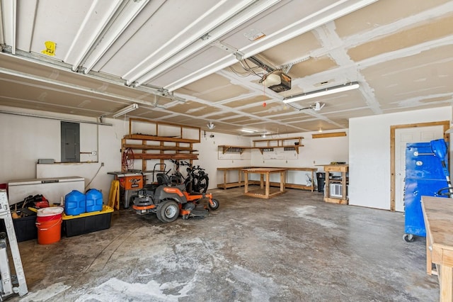 75 N Hill Rd, Kalispell, MT 59901 - garage featuring a garage door opener, electric panel, and a workshop area