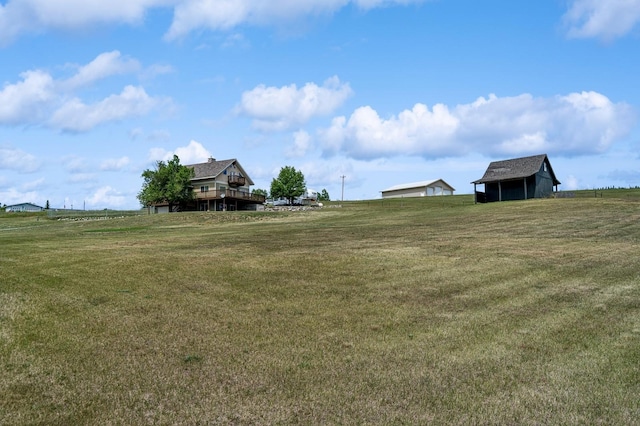 75 N Hill Rd, Kalispell, MT 59901 - view of grassy yard with an outdoor structure and a view of rural / pastoral area