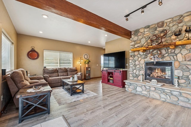 75 N Hill Rd, Kalispell, MT 59901 - living room with beam ceiling, healthy amount of natural light, wood finished floors, a fireplace, and recessed lighting
