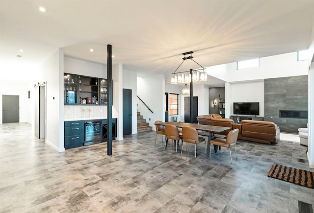 4722 Skalkaho Rd, Philipsburg, MT 59858 - dining area featuring beverage cooler, bar area, recessed lighting, stairway, and healthy amount of natural light