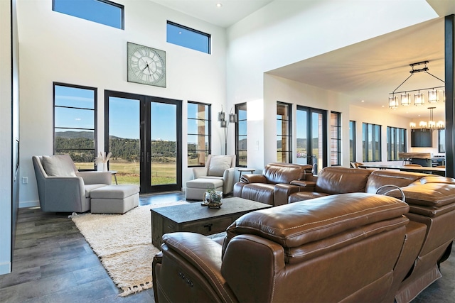 4722 Skalkaho Rd, Philipsburg, MT 59858 - living room with a chandelier, wood finished floors, a high ceiling, and a mountain view