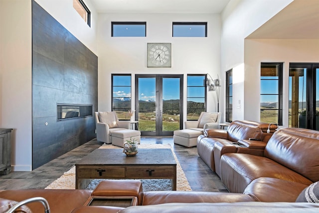 4722 Skalkaho Rd, Philipsburg, MT 59858 - living room featuring a tile fireplace, a high ceiling, and wood finished floors